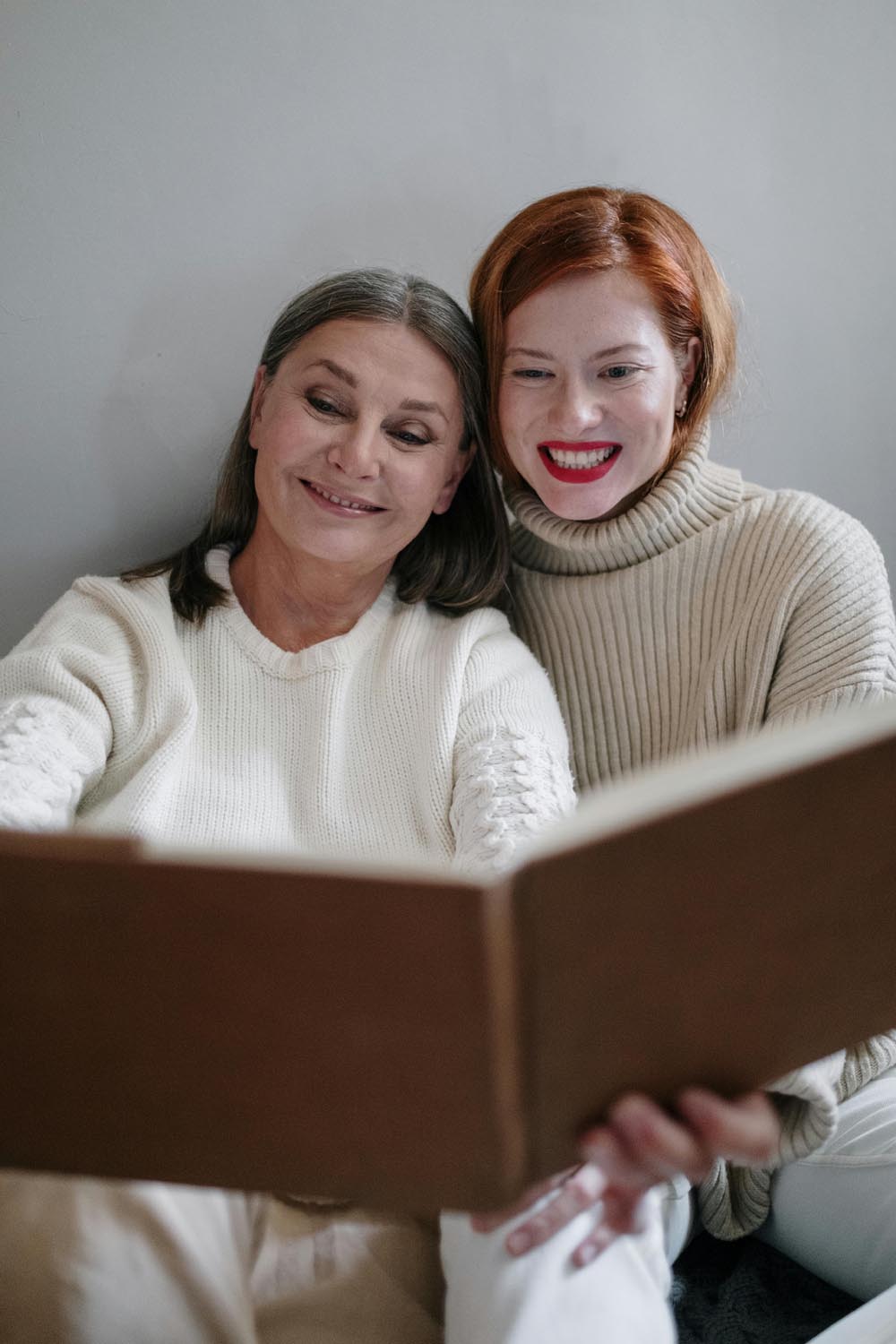 Two people reading together symbolizing kindness, emotional clarity and connection in Maryland and DC.