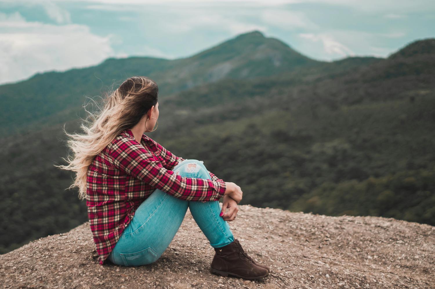 A person sitting in the mountains, symbolizing self examination and emotional reflection in Maryland and DC