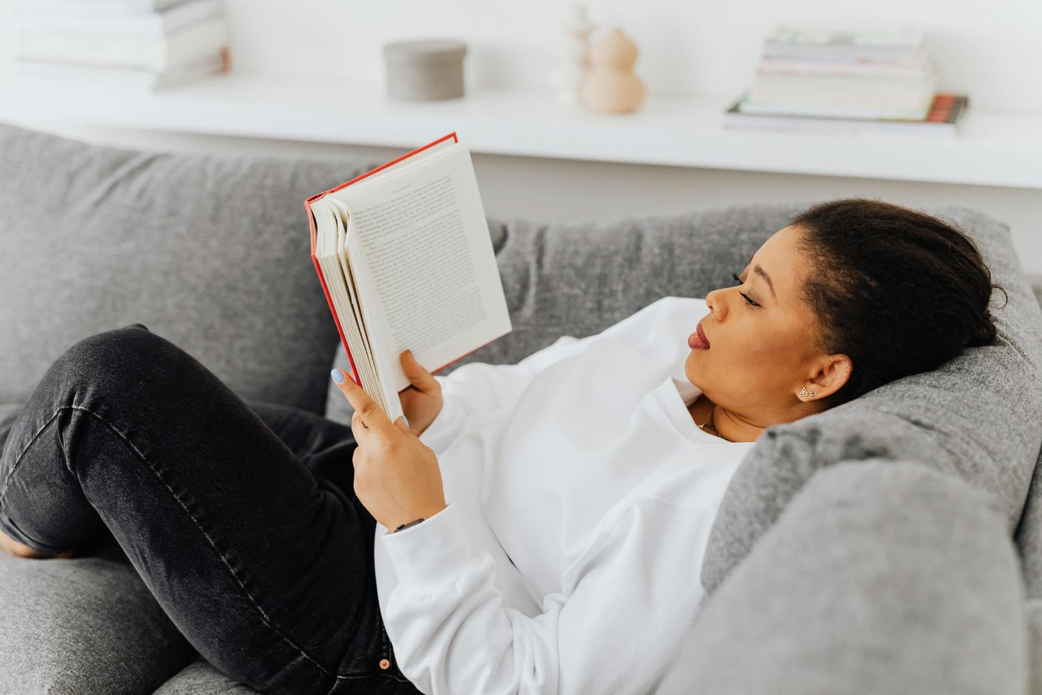 Person reading short story about family gathered around a dinner table with laughter and conversation to figure out what is worth doing, symbolizing emotional connection in Maryland and DC.