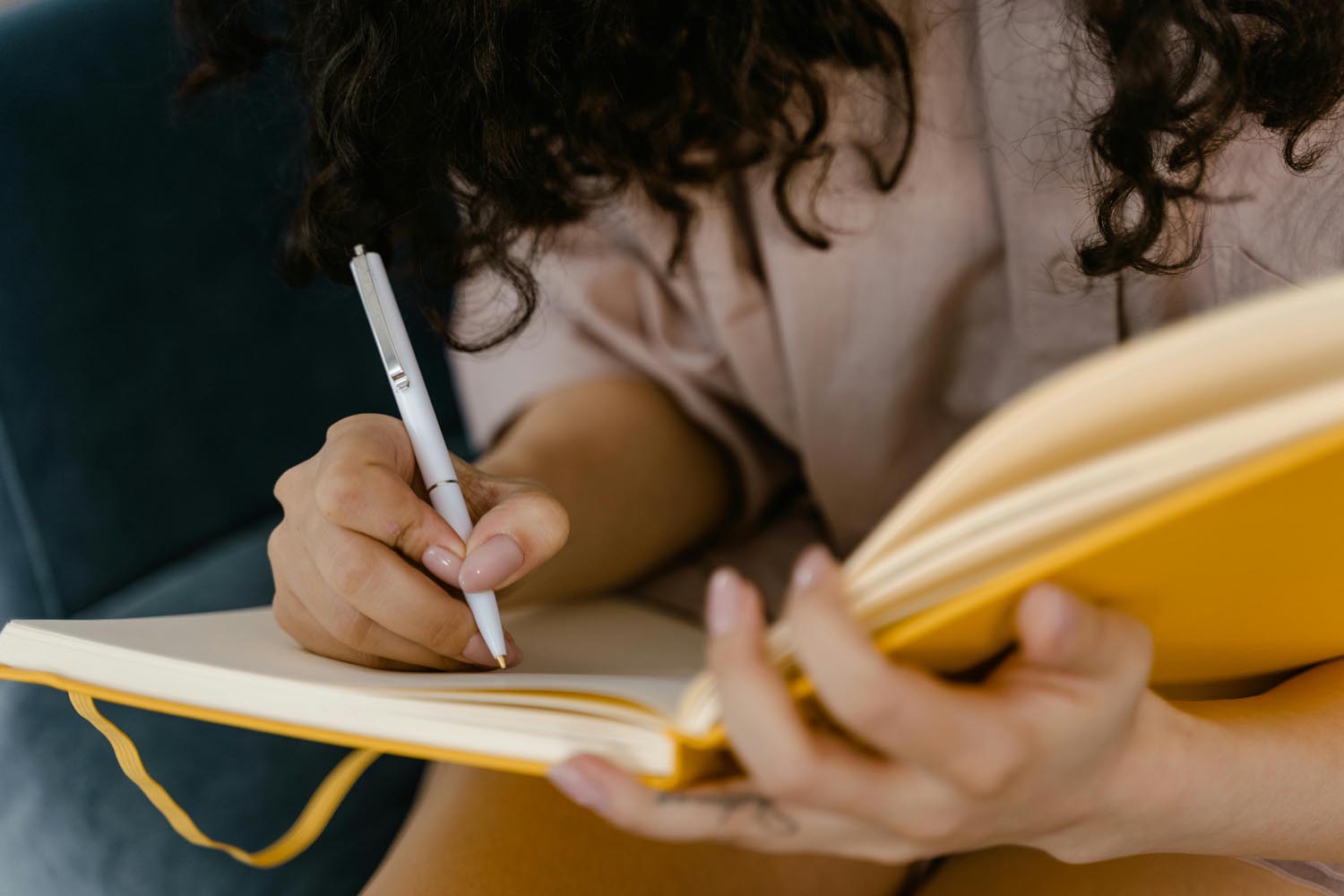 Person writing about a confident child leading peers in a school play, symbolizing natural leadership and group dynamics in Maryland and DC.