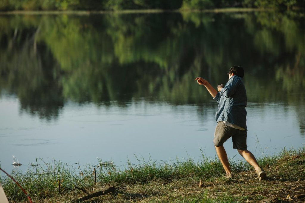Man walking on the shore, being emotionally charged.