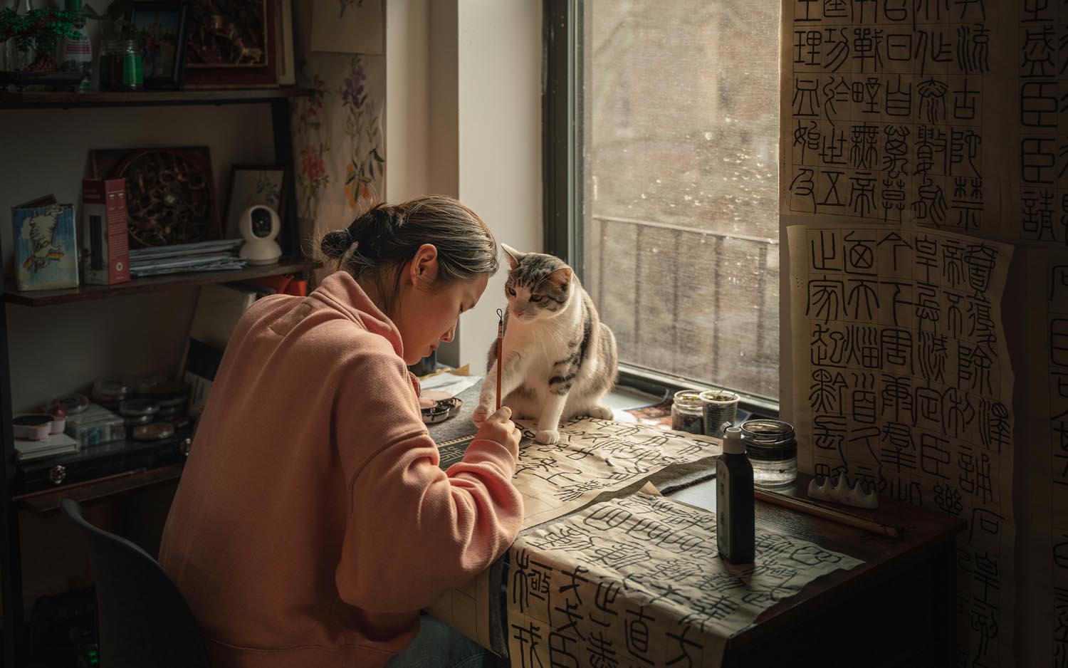 Woman sitting next to a vintage record spinning beside a journal, symbolizing memory and emotional resonance in Maryland and DC.