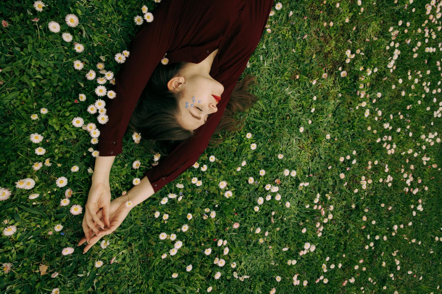 Woman lying in a field, symbolizing renewal and emotional growth and memory and meaning in Maryland and DC.