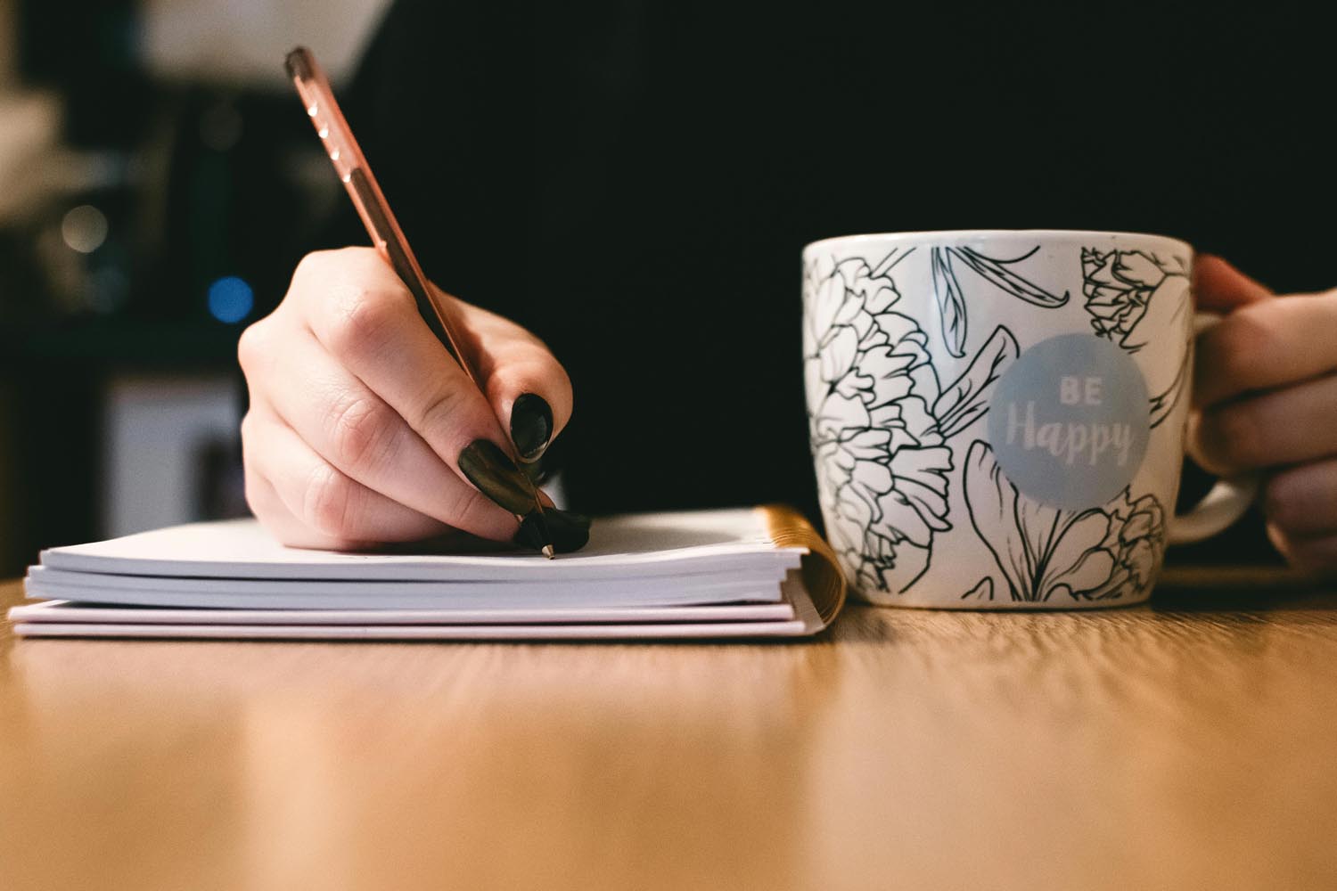 A journal and calendar beside a warm drink, symbolizing year-end reflection and emotional resilience in Maryland and DC.