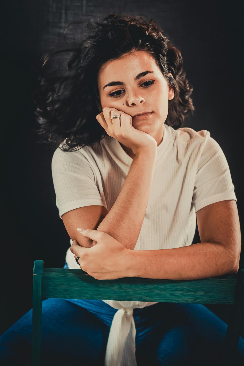 A parent, waiting and filled with regret about failure, sitting quietly on a park bench displaying empathy and courage, waiting for a package after a sorting delay, symbolizing resistance, emotional distance, and the potential for reconnection in Maryland and DC.