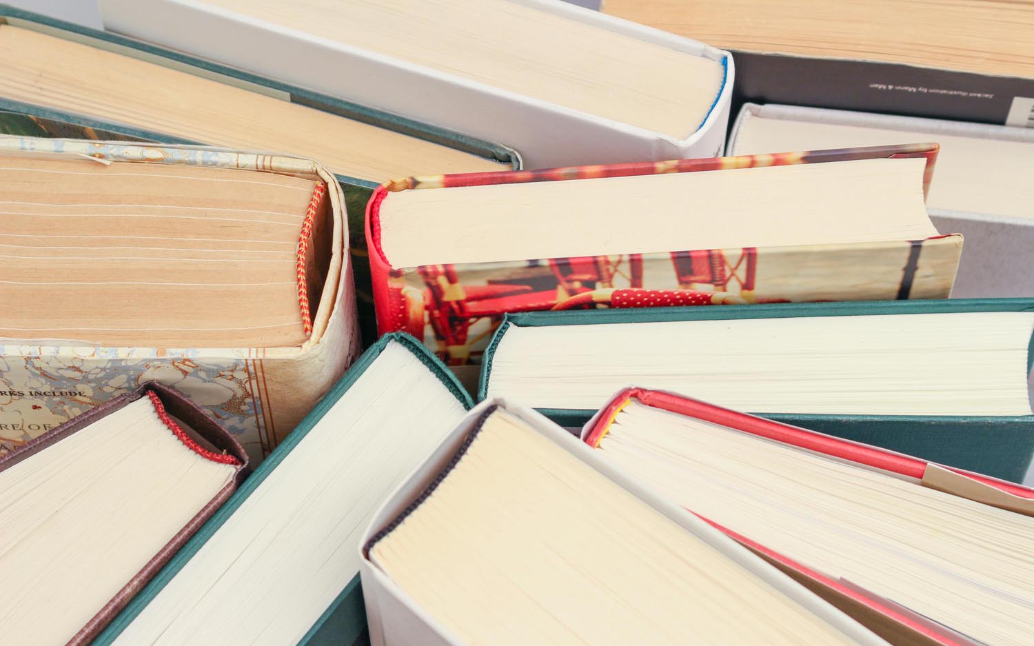 Vintage psychology books that are imbalance and are beside a journal, symbolizing emotional reflexes and childhood conditioning in Maryland and DC.