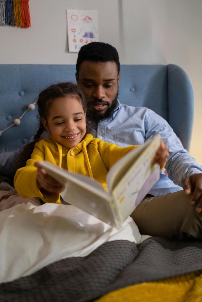 Father and daughter reading on National Hugging Day about a connected gray whale surfacing in the Atlantic Ocean, symbolizing emotional anchors, struggling emotionally. caring and memory in Maryland and DC.