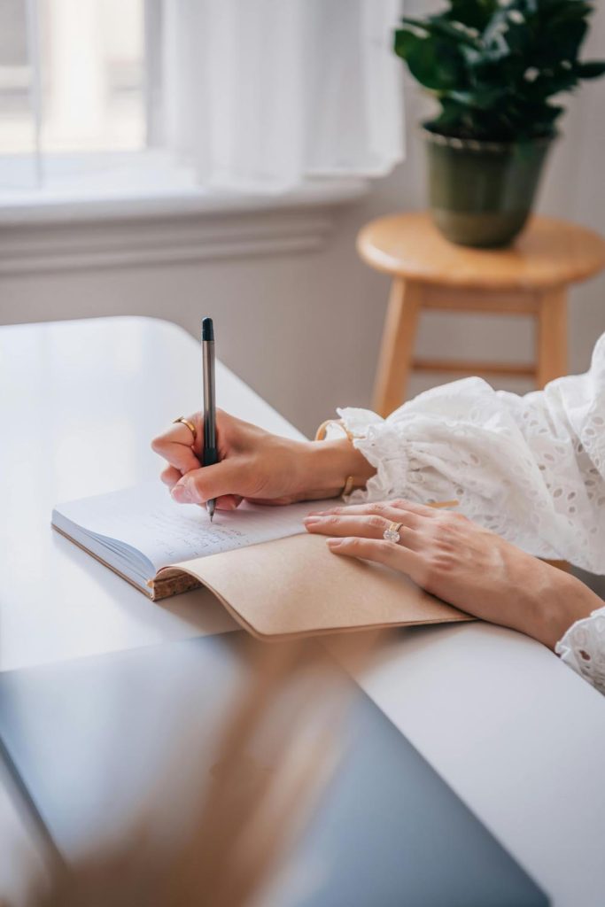 A woman drafting a handwritten letter with her feelings in life, symbolizing the power of connection in Maryland and DC.