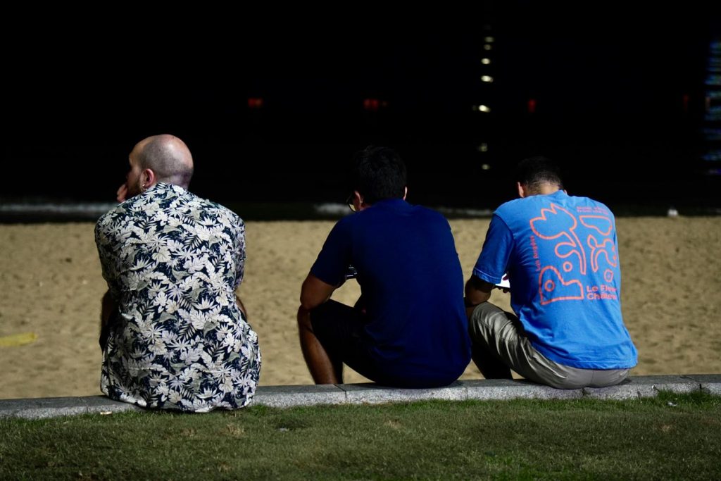A group of people watching a graduate toss a cap into the air beside friends in spring, symbolizing growth and emotional transition in Maryland and DC.