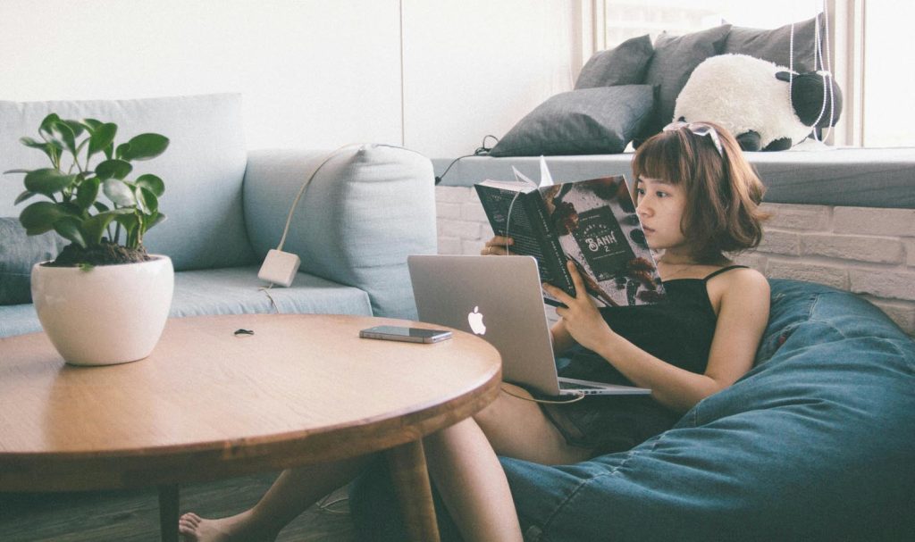 A woman studying on round table next to appliances which Influences Connection and Conversation , symbolizing compassion and the origins of civilization in Maryland and DC.