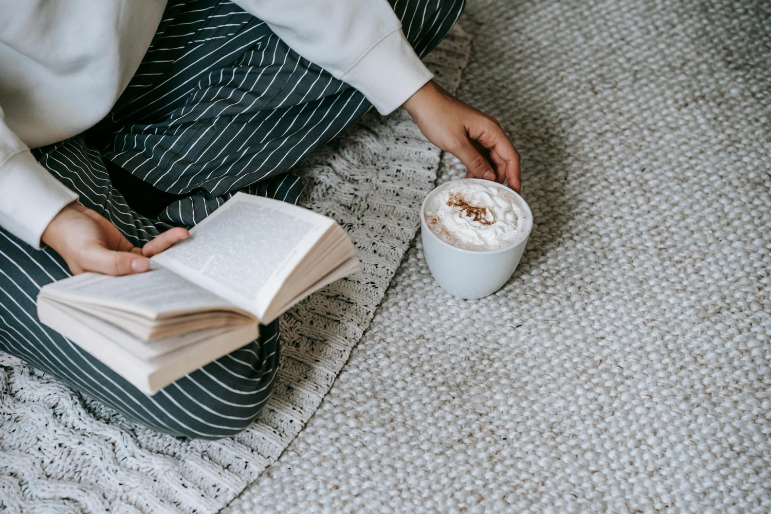 A woman on a Sunday morning reading about two female gladiators in combat, symbolizing cultural violence and emotional reflection in Maryland and DC.