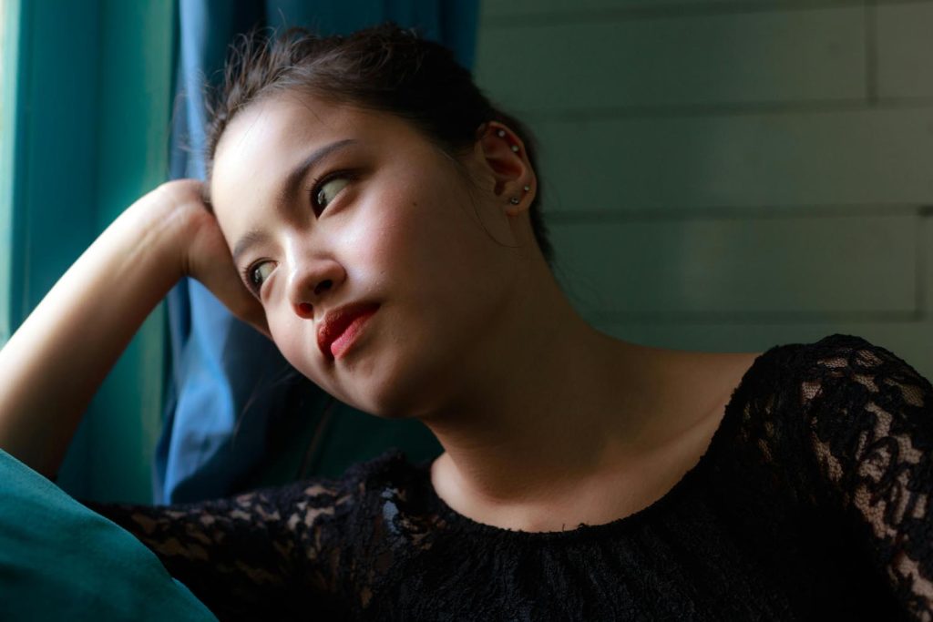 A woman thinking about the tradition of high heels, symbolizing fashion history and emotional patterns in Maryland and DC.