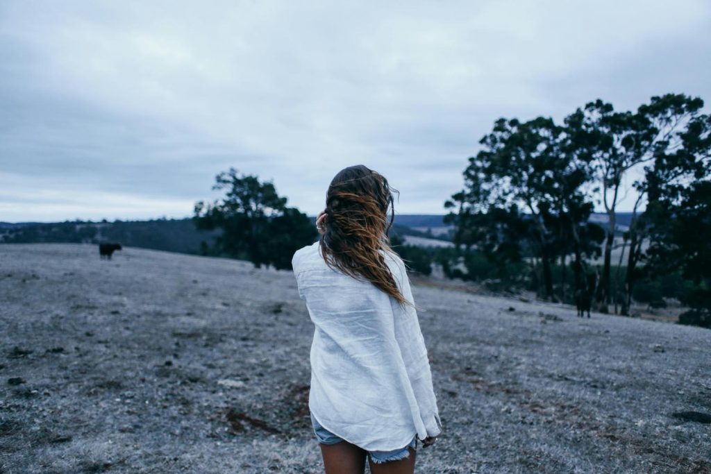 Woman outside in February in winter belonging in nature, symbolizing seasonal reflection and emotional wellness in Maryland and DC.