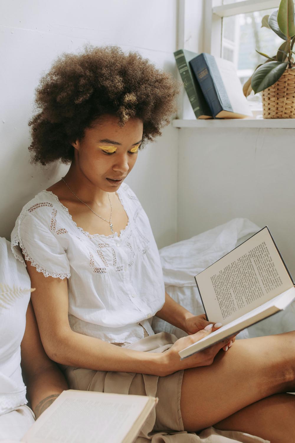 A woman reading about self-worth and identity after falling for relationship scams, symbolizing garage girl friendship and emotional connection in Maryland and DC.