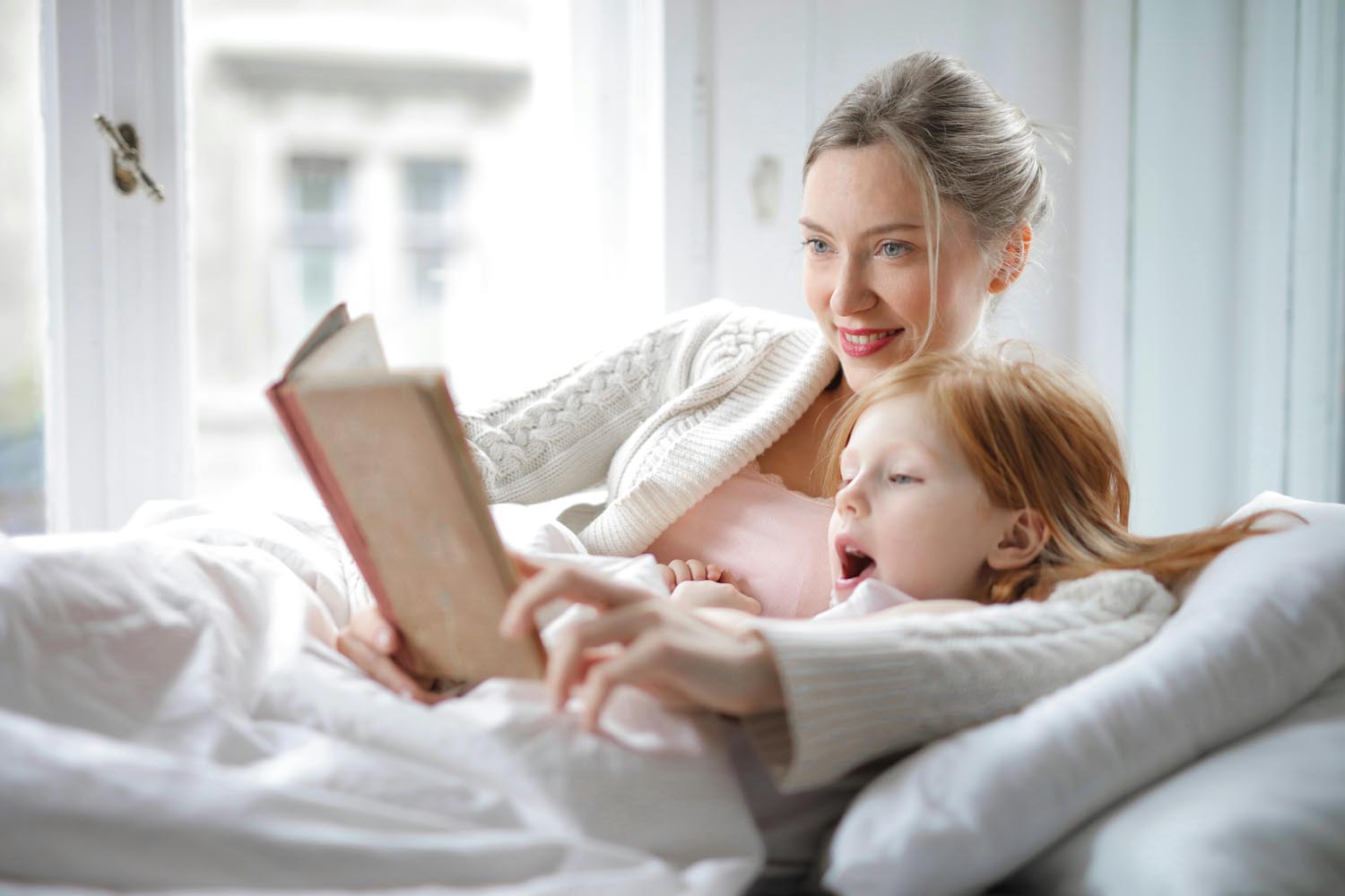 Woman sitting on a sofa with familiar routines with her daughter thinking on how No One Prepares Us to Parent , symbolizing reflection and reconnection during marriage in the age of COVID-19, with therapy support in Maryland and DC.