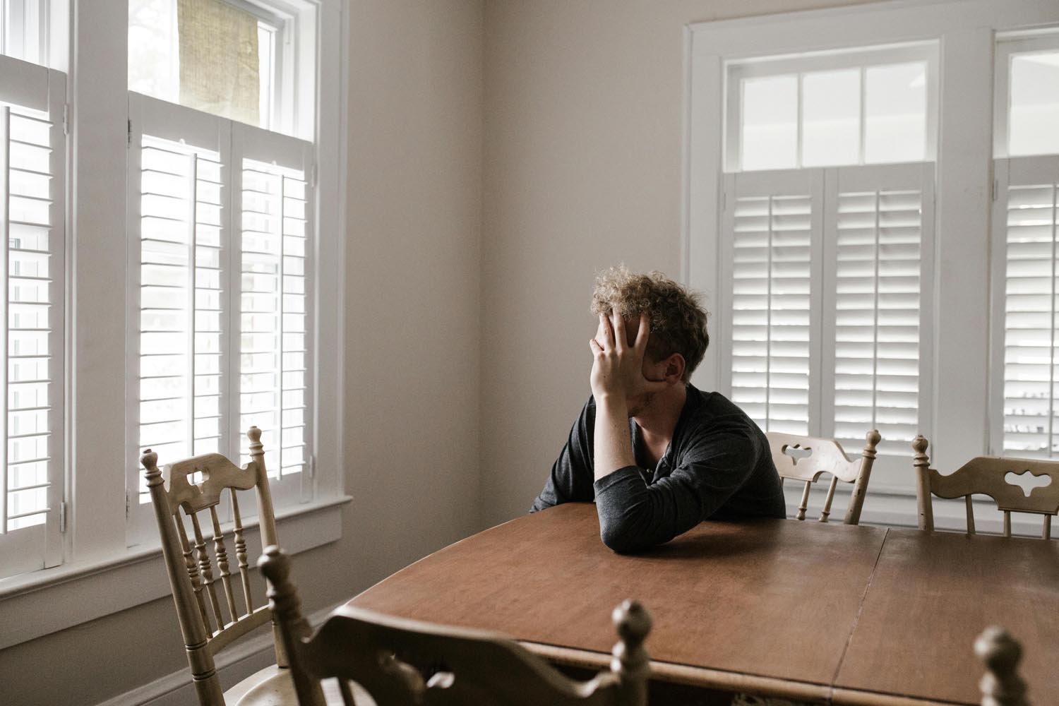 Man reflecting on paternal age effects and autism risk in online therapy in Maryland and DC.