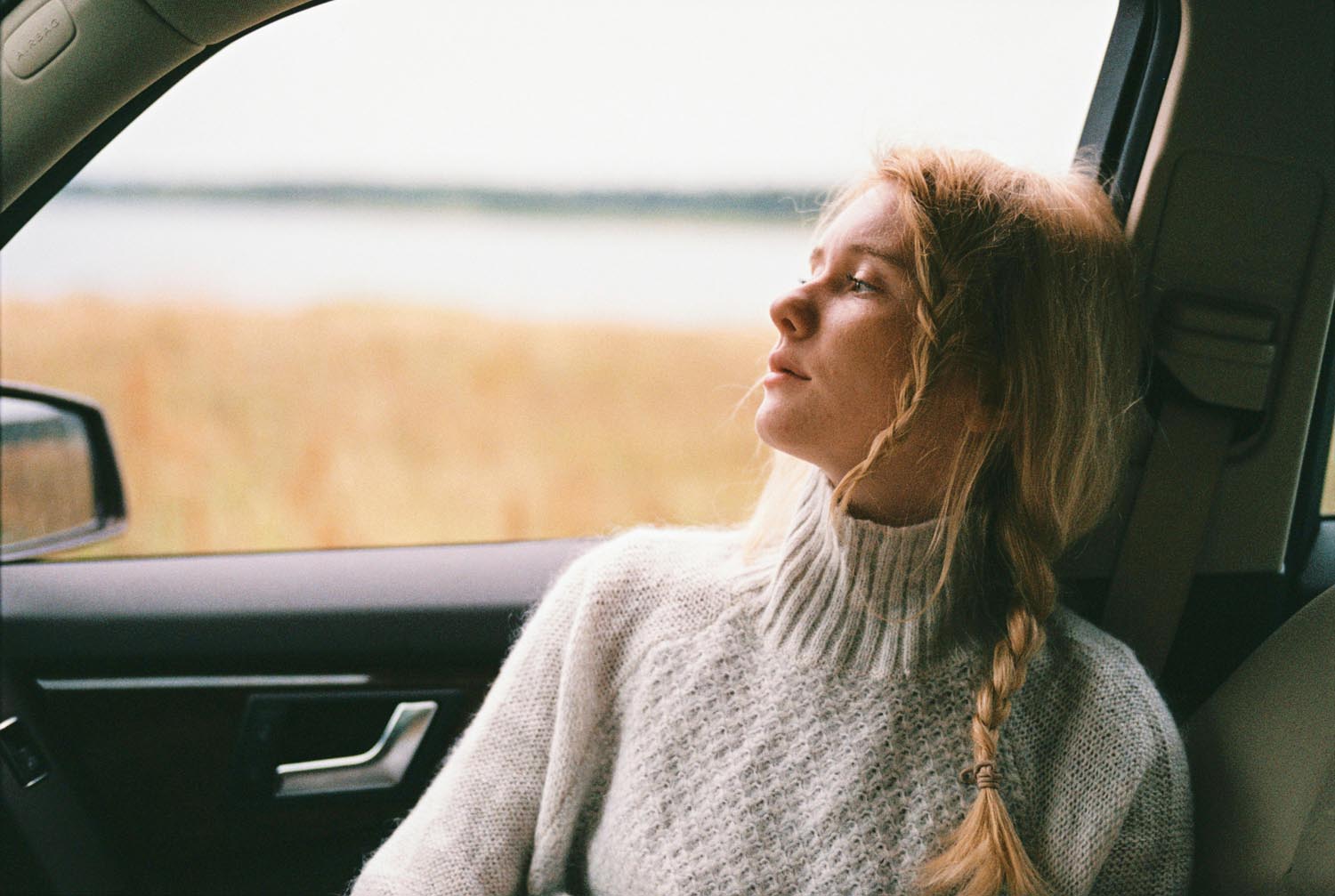 A woman thinking about her Coming-of-Age Chaos after a meeting around a table, symbolizing transformation through collaborative divorce and online therapy in Maryland and DC.