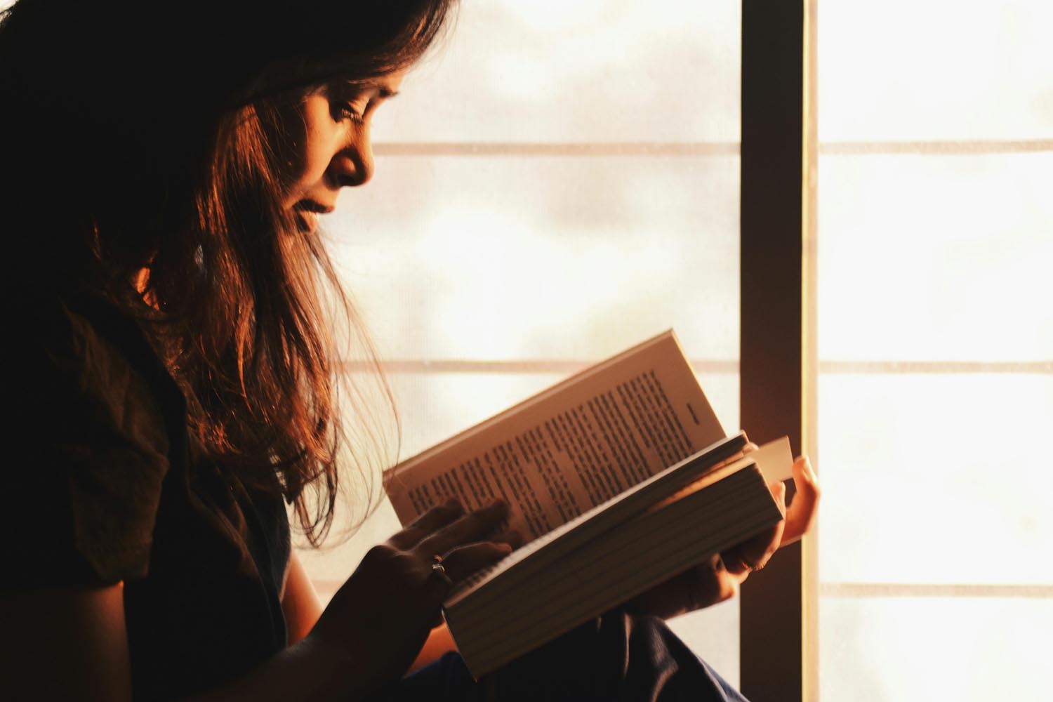 Woman reading calmly after a supportive therapy session, reflecting the collaborative divorce process and online therapy in Maryland and DC.