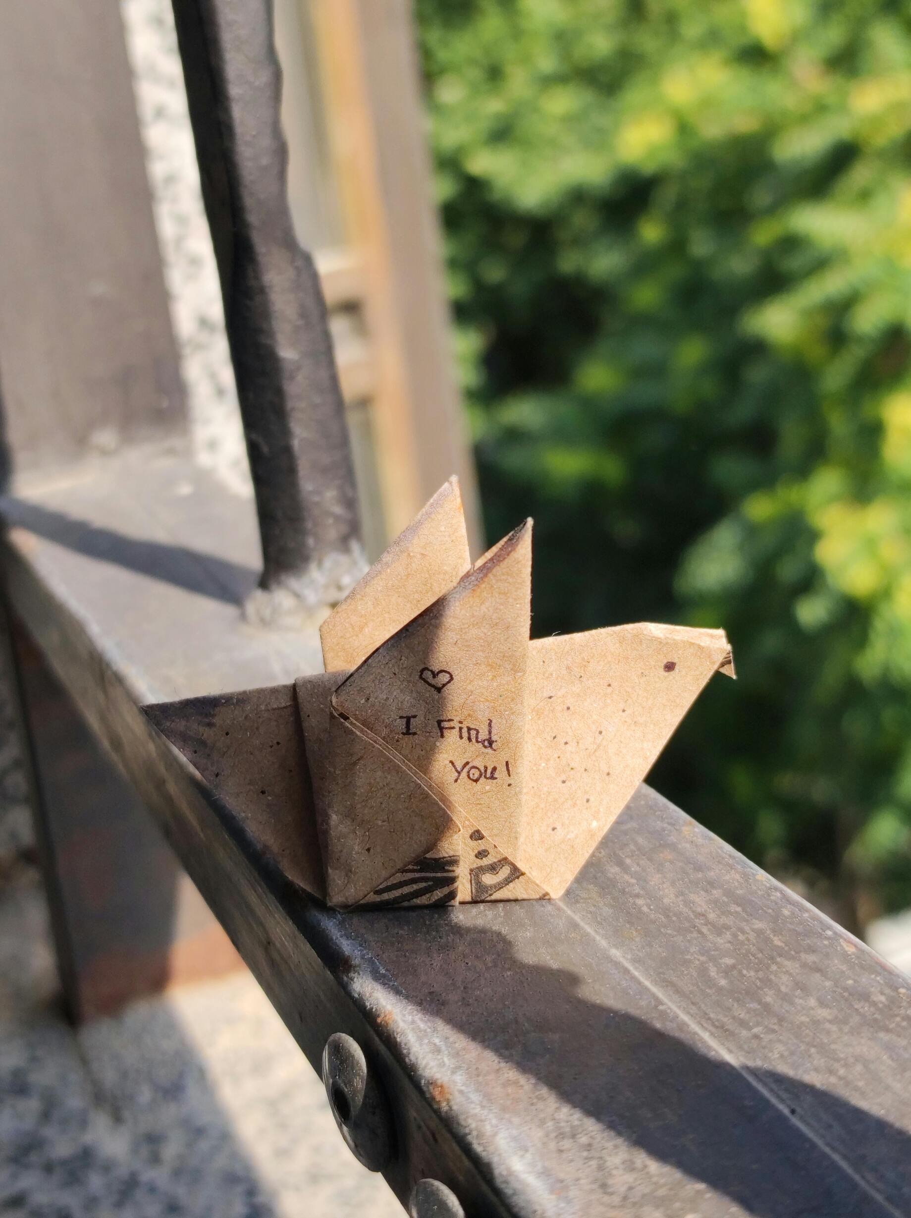 A folded paper cootie catcher resting on a table, symbolizing creativity and unfolding potential.